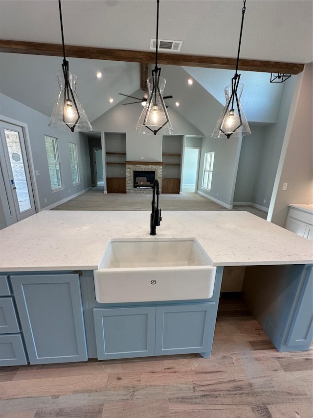 544 Aermotor Loop, Weatherford, TX 76085 - kitchen featuring a sink, open floor plan, a kitchen island with sink, ceiling fan, and light wood-style floors