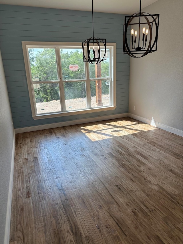 544 Aermotor Loop, Weatherford, TX 76085 - unfurnished dining area with a chandelier, healthy amount of natural light, baseboards, and wood finished floors