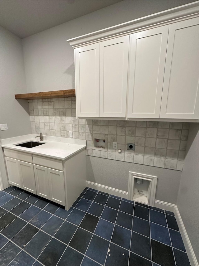 544 Aermotor Loop, Weatherford, TX 76085 - laundry area featuring cabinet space, washer hookup, dark tile patterned floors, and baseboards