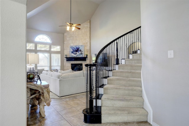 320 Trakehner Trl, Celina, TX 75009 - stairway featuring tile patterned floors, high vaulted ceiling, ceiling fan, and a fireplace