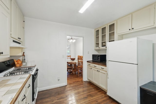 7348 Pensacola Ave, Fort Worth, TX 76116 - kitchen with black gas range, freestanding refrigerator, tile counters, stainless steel microwave, and dark wood-style flooring