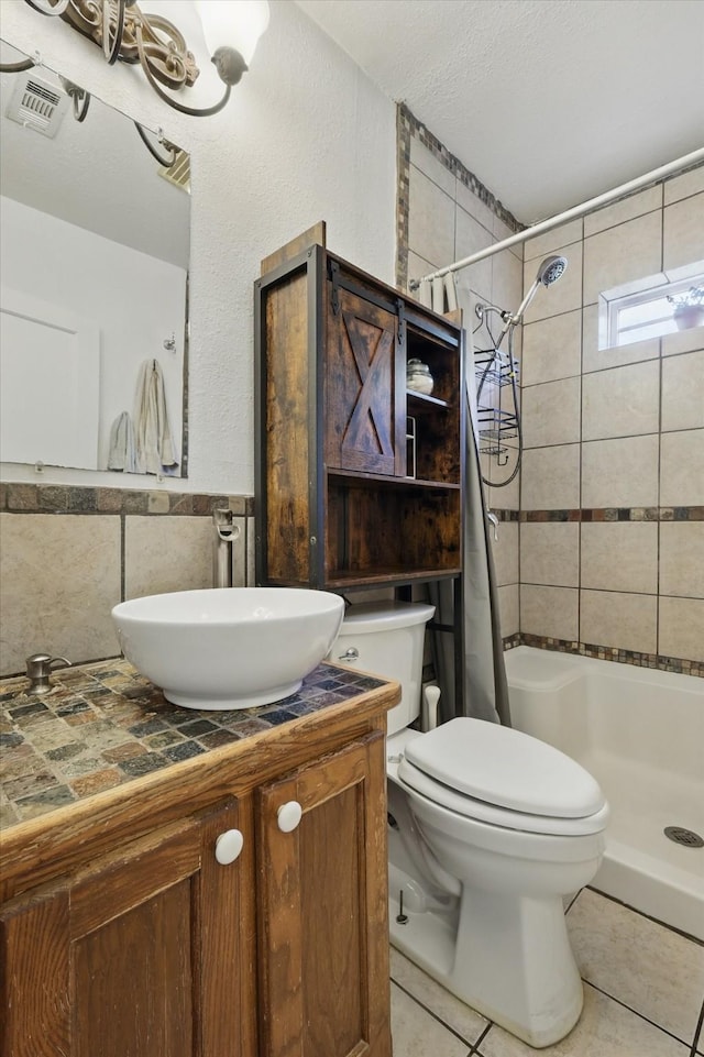 7348 Pensacola Ave, Fort Worth, TX 76116 - bathroom featuring a shower with shower curtain, toilet, tile patterned floors, vanity, and a textured ceiling