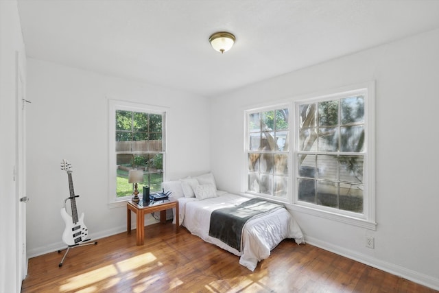 7348 Pensacola Ave, Fort Worth, TX 76116 - bedroom with multiple windows, wood finished floors, and baseboards