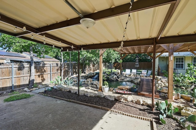 7348 Pensacola Ave, Fort Worth, TX 76116 - view of patio with a small pond and a fenced backyard