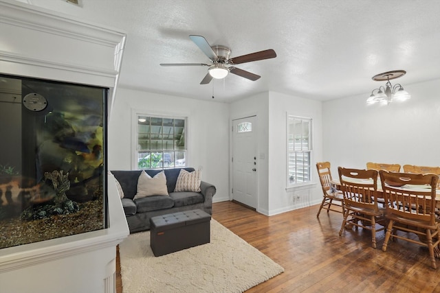 7348 Pensacola Ave, Fort Worth, TX 76116 - living area with hardwood / wood-style flooring, ceiling fan, baseboards, and a chandelier