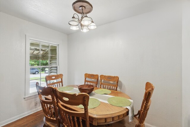 7348 Pensacola Ave, Fort Worth, TX 76116 - dining area with baseboards, dark wood finished floors, and a chandelier