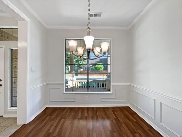 6400 Hawthorn Dr, Denton, TX 76208 - unfurnished dining area with a chandelier, dark wood-type flooring, a wainscoted wall, and ornamental molding