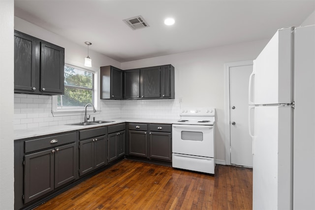 2320 Herring Ave, Waco, TX 76708 - kitchen with a sink, white appliances, dark wood-style flooring, light countertops, and backsplash