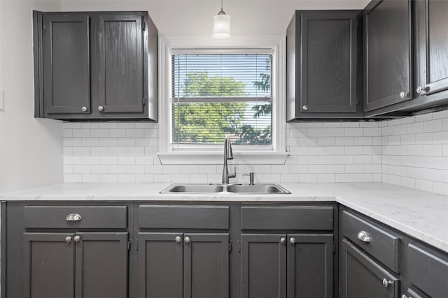 2320 Herring Ave, Waco, TX 76708 - kitchen featuring a sink, tasteful backsplash, gray cabinetry, and decorative light fixtures