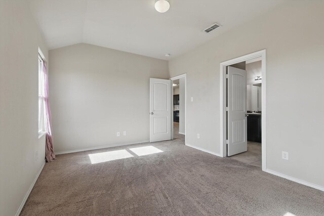 309 Pimlico Way, Ponder, TX 76259 - unfurnished bedroom with carpet floors, vaulted ceiling, baseboards, and ensuite bathroom