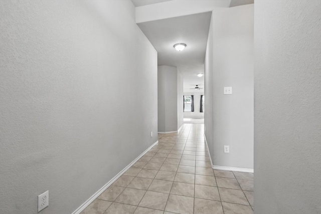 309 Pimlico Way, Ponder, TX 76259 - hall with light tile patterned floors, a textured wall, and baseboards
