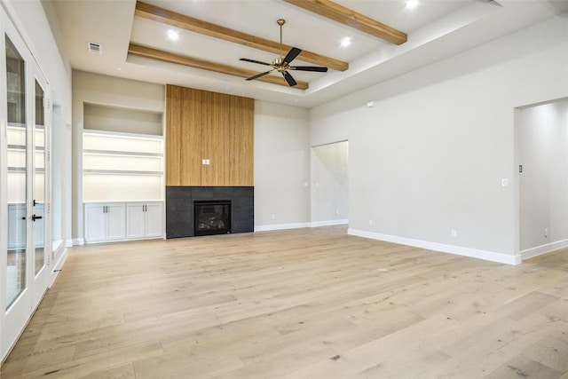 3621 Barber Crk, Fort Worth, TX 76244 - unfurnished living room featuring ceiling fan, a large fireplace, light wood-type flooring, french doors, and beam ceiling