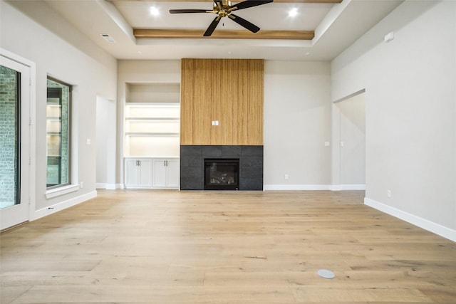 3621 Barber Crk, Fort Worth, TX 76244 - unfurnished living room with a tray ceiling, light wood-style floors, a ceiling fan, a tile fireplace, and recessed lighting