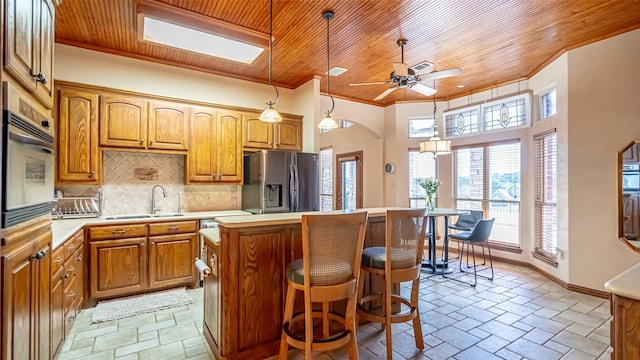1905 Yucatan Dr, Granbury, TX 76048 - kitchen featuring stainless steel refrigerator with ice dispenser, a sink, wood ceiling, a center island, and a ceiling fan