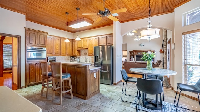 1905 Yucatan Dr, Granbury, TX 76048 - kitchen with stainless steel appliances, wooden ceiling, ceiling fan, crown molding, and plenty of natural light