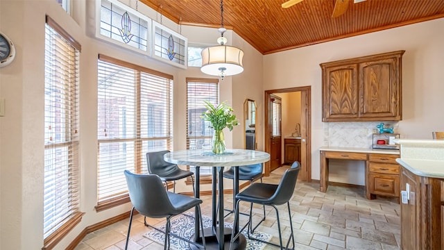 1905 Yucatan Dr, Granbury, TX 76048 - dining room with wood ceiling, stone tile floors, crown molding, a ceiling fan, and baseboards