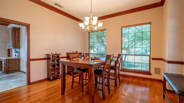 1905 Yucatan Dr, Granbury, TX 76048 - dining area featuring crown molding, light wood-style flooring, a chandelier, and baseboards