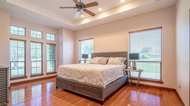 1905 Yucatan Dr, Granbury, TX 76048 - bedroom featuring light wood-type flooring, recessed lighting, a tray ceiling, baseboards, and ceiling fan