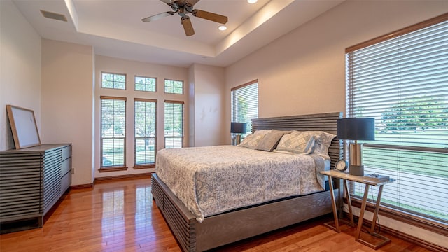 1905 Yucatan Dr, Granbury, TX 76048 - bedroom featuring light wood-style flooring, a raised ceiling, baseboards, recessed lighting, and a ceiling fan