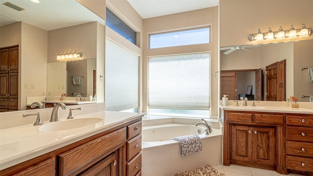 1905 Yucatan Dr, Granbury, TX 76048 - full bathroom featuring a jetted tub, two vanities, a ceiling fan, and tile patterned flooring