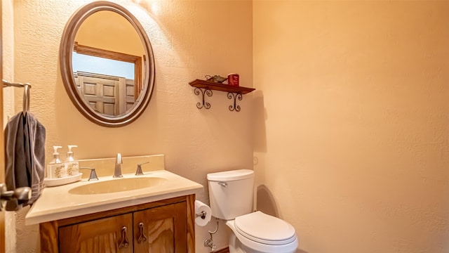 1905 Yucatan Dr, Granbury, TX 76048 - half bath featuring toilet, vanity, and a textured wall