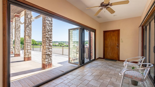 1905 Yucatan Dr, Granbury, TX 76048 - doorway featuring stone tile floors, baseboards, ceiling fan, and a water view