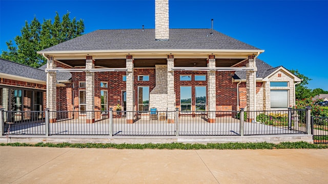 1905 Yucatan Dr, Granbury, TX 76048 - rear view of house featuring fence, a patio area, brick siding, and a chimney