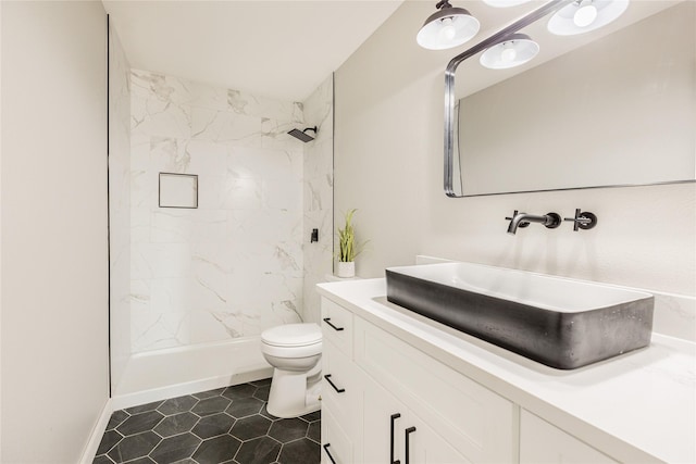 bathroom with vanity, toilet, a shower, and tile patterned floors