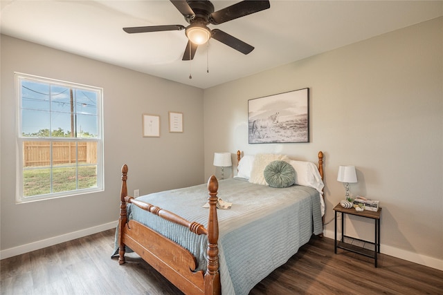 bedroom with baseboards, wood finished floors, and a ceiling fan