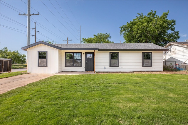 view of front of property with a front yard and board and batten siding