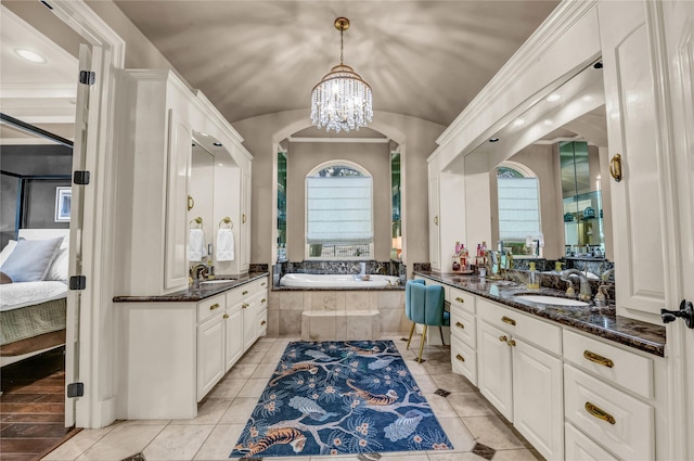 124 Oakvista Dr, Aledo, TX 76008 - full bathroom with two vanities, a bath, ensuite bathroom, a chandelier, and lofted ceiling