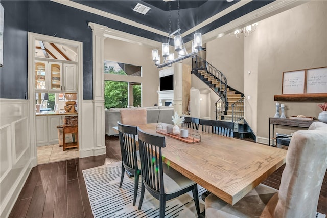 124 Oakvista Dr, Aledo, TX 76008 - dining area with a chandelier, stairs, wood finished floors, wainscoting, and a decorative wall