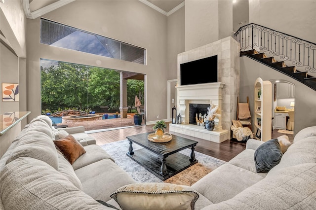 124 Oakvista Dr, Aledo, TX 76008 - living room featuring a high ceiling, wood finished floors, crown molding, a fireplace, and stairway