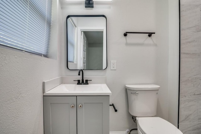 bathroom featuring toilet and vanity