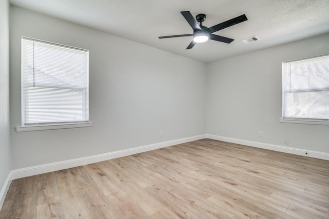 empty room with light wood-style flooring, baseboards, and ceiling fan