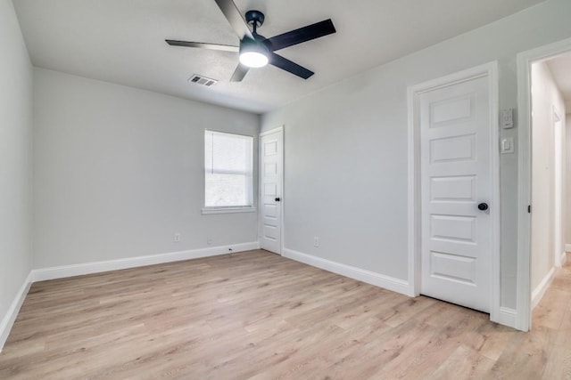 unfurnished bedroom featuring light wood-type flooring, baseboards, and a ceiling fan