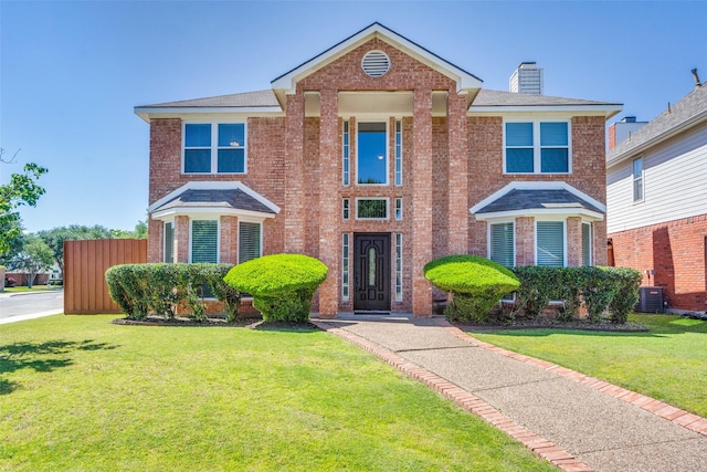 4136 Timberglen Rd, Dallas, TX 75287 - traditional-style house featuring brick siding, a chimney, and a front yard