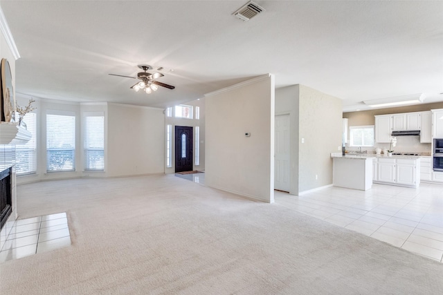 4136 Timberglen Rd, Dallas, TX 75287 - unfurnished living room featuring light carpet, healthy amount of natural light, ceiling fan, and crown molding