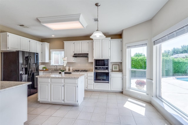 4136 Timberglen Rd, Dallas, TX 75287 - kitchen with black appliances, under cabinet range hood, decorative backsplash, and white cabinets