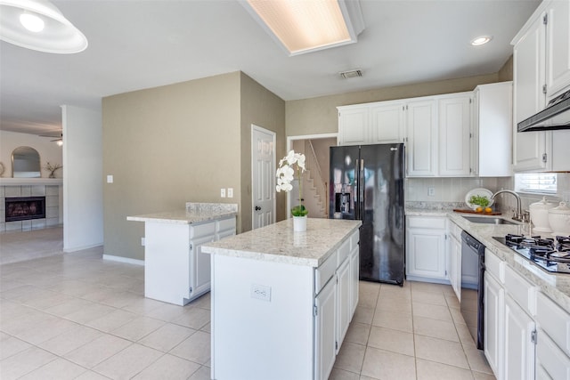 4136 Timberglen Rd, Dallas, TX 75287 - kitchen featuring black appliances, a sink, a center island, light tile patterned floors, and recessed lighting