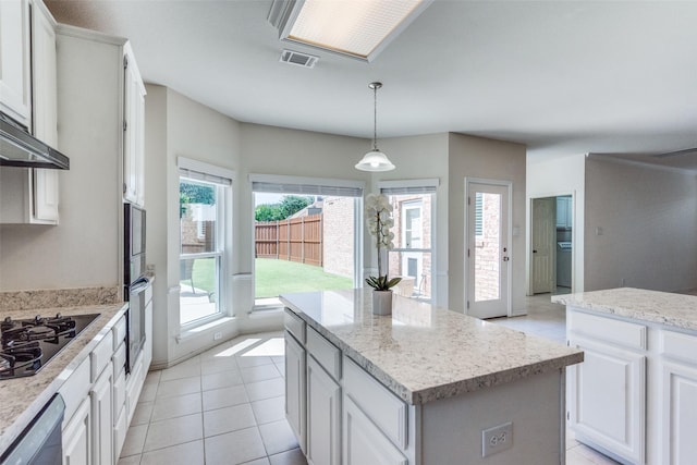 4136 Timberglen Rd, Dallas, TX 75287 - kitchen featuring black appliances, a center island, plenty of natural light, and white cabinetry