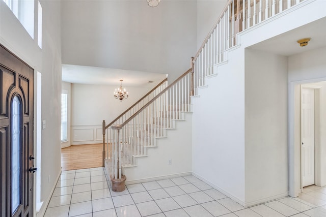 4136 Timberglen Rd, Dallas, TX 75287 - entrance foyer with a high ceiling, light tile patterned flooring, stairway, and a chandelier