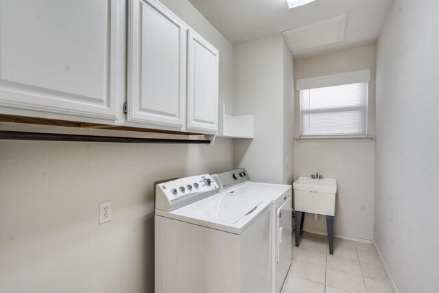 4136 Timberglen Rd, Dallas, TX 75287 - clothes washing area with cabinet space, washer and dryer, light tile patterned flooring, attic access, and baseboards