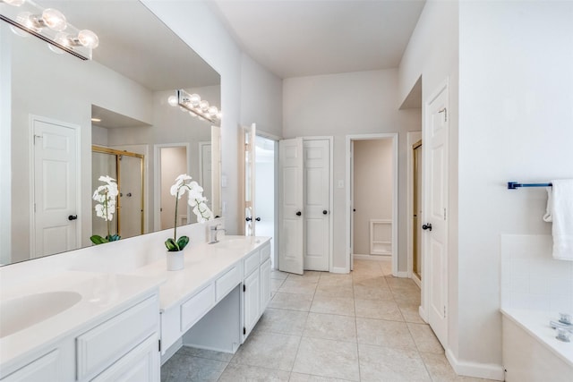 4136 Timberglen Rd, Dallas, TX 75287 - full bath featuring a stall shower, double vanity, a garden tub, tile patterned floors, and baseboards