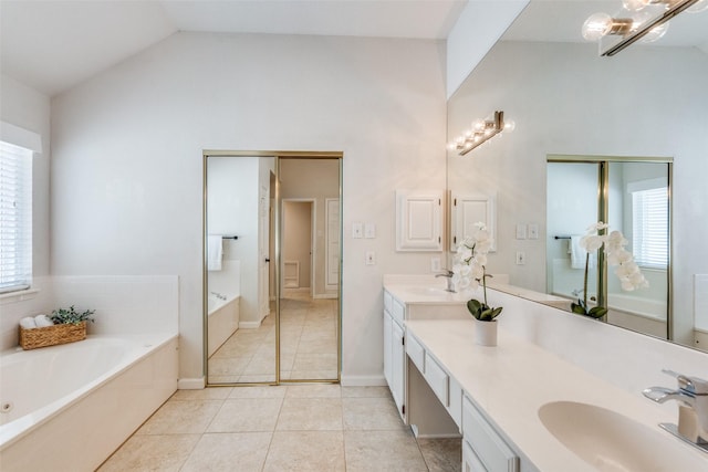 4136 Timberglen Rd, Dallas, TX 75287 - bathroom featuring plenty of natural light, a bath, tile patterned floors, high vaulted ceiling, and double vanity