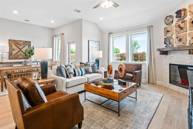 300 Thorn Creek Dr, Anna, TX 75409 - living room with light wood-style floors, ceiling fan, a stone fireplace, lofted ceiling, and recessed lighting