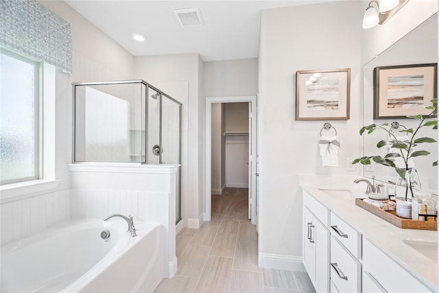 300 Thorn Creek Dr, Anna, TX 75409 - bathroom featuring a shower stall, a bath, double vanity, a walk in closet, and baseboards