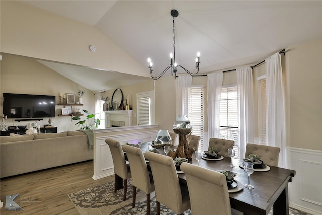 5249 Western Plains Ave, Abilene, TX 79606 - dining area featuring a chandelier, lofted ceiling, wood finished floors, and a wainscoted wall