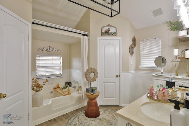 5249 Western Plains Ave, Abilene, TX 79606 - full bathroom with lofted ceiling, a bath, wood finished floors, healthy amount of natural light, and vanity