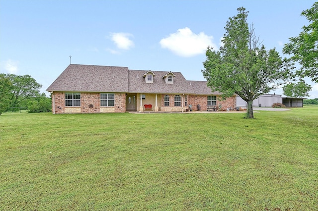 10142 W Fm 1753, Savoy, TX 75479 - cape cod-style house featuring a front yard, brick siding, and roof with shingles